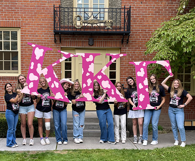 Kappa Kappa Gamma members holding giant letters.